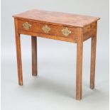 An 18th Century oak side table fitted a frieze drawer with brass drop handles, raised on square