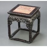 A Chinese square carved and pierced hardwood jardiniere stand inset a pink veined marble top 42cm