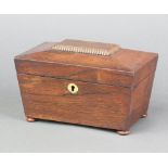 A 19th Century rosewood twin compartment tea caddy of sarcophagus form with brass escutcheon, raised
