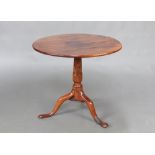 An 18th/19th Century circular yew snap top tea table, raised on a turned column and tripod base 58cm