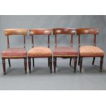A set of 4 19th Century bar back dining chairs with overstuffed seats, raised on turned and reeded
