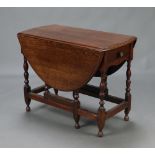 An 18th Century oval drop flap gateleg dining table fitted a drawer, raised on turned supports