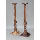 A pair of William IV circular turned mahogany bedpost torcheres raised on stepped square bases 133cm