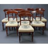 A set of 8 19th Century mahogany bar back dining chairs with shaped mid rails and overstuffed seats