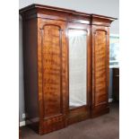A Victorian triple inverted breakfront wardrobe with moulded cornice, the centre section fitted 4