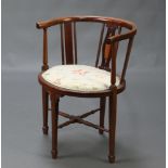 An Edwardian inlaid mahogany stick and rail tub back chair with upholstered seat, raised on square