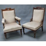 An Edwardian carved walnut show frame open arm chair upholstered in mushroom coloured material,