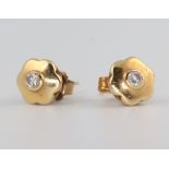 A pair of yellow metal 18ct diamond ear studs. 2.4 grams