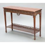 A Victorian Chippendale style rosewood side table with blind fretwork decoration, the under tier