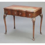 A Queen Anne style walnut writing table of serpentine outline fitted a green inset writing surface