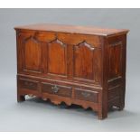 A 18th Century oak mule chest of panelled construction with hinged lid, base with arcaded panel to