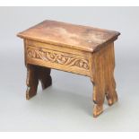 An Ipswich style carved oak stool/coffer with hinged lid raised on standard end supports 45cm h x