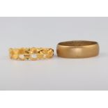 A 22ct gold yellow gold wedding band size J 1/2 3.9 grams and a yellow metal ring, size J, 2 grams