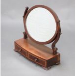 A Georgian oval bevelled plate dressing table mirror contained in inlaid mahogany frame, the