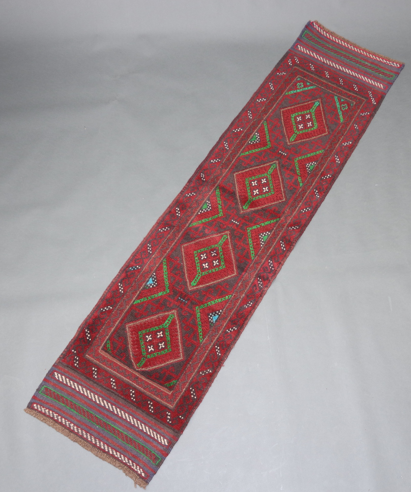 A red, blue and green ground Mashwani runner with 4 diamonds to the centre 241cm x 59cm