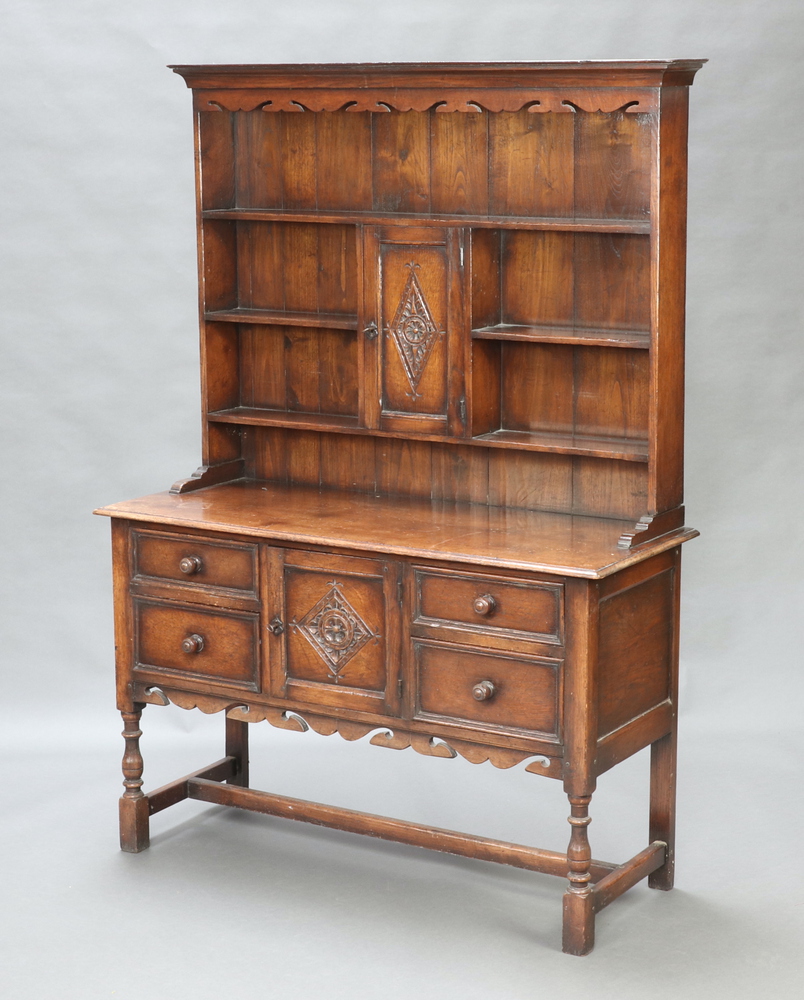 A 17th Century style carved oak dresser in the Ipswich manner, the back with pierced and moulded