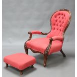 A Victorian carved mahogany show frame open armchair upholstered in red and gold buttoned