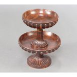 A Georgian style circular turned and fluted mahogany 2 tier table centrepiece raised on outswept