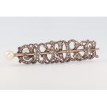 An Edwardian yellow metal diamond and pearl set bar brooch, 9 grams, 40mm