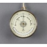 A 19th/20th Century aneroid barometer with 12cm silvered dial, contained in a gilt metal case
