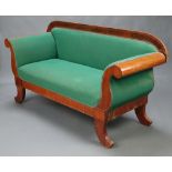 A Biedermeier style inlaid mahogany show frame sofa upholstered in green material, raised on