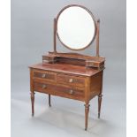 An Edwardian inlaid mahogany dressing chest with circular bevelled plate mirror to the back, the