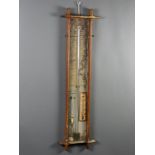 A Fitzroy barometer contained in an oak Oxford framed case 102cm h x 28cm w x 4cm d Paper labels