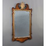 A 1950's Chippendale style rectangular plate mirror contained in a walnut frame 89cm h x 47cm