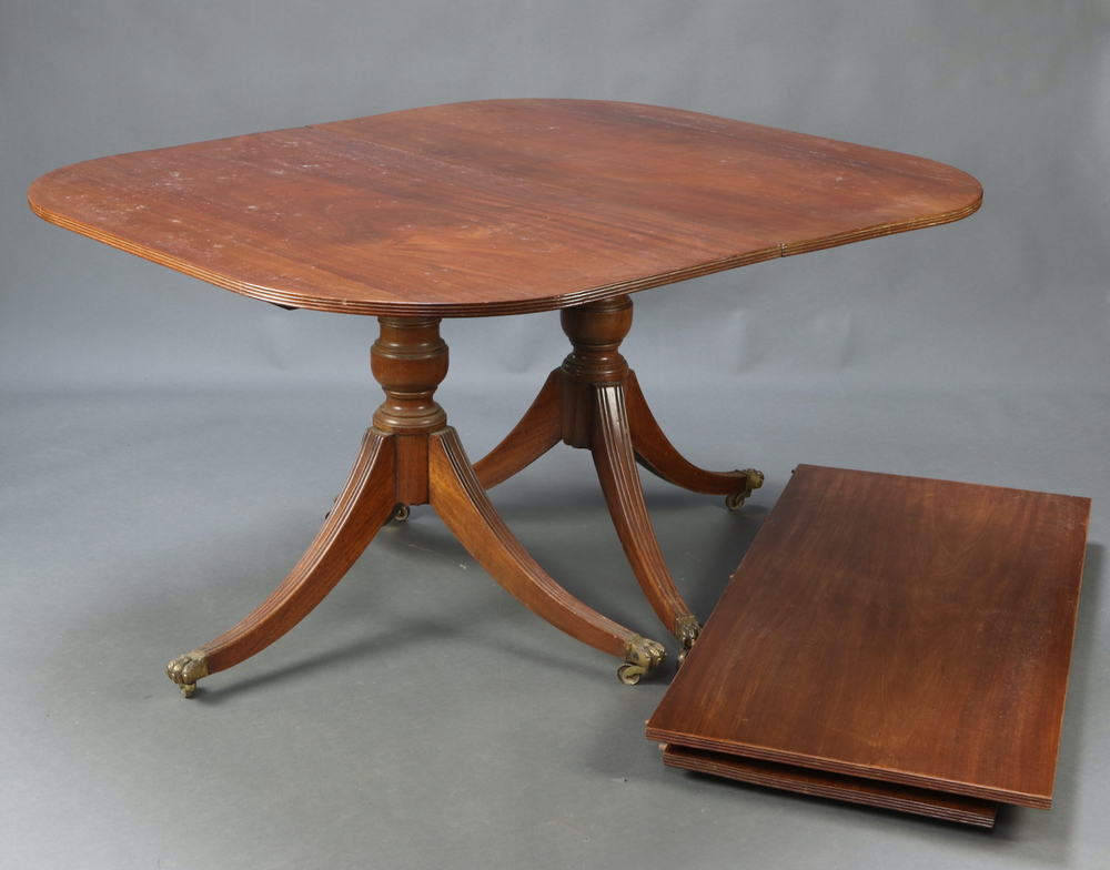 A Georgian style mahogany twin pillar extending dining table with 2 extra leaves 75cm h x 118cm w