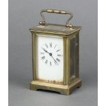 A 19th Century French 8 day carriage timepiece with 5cm dial, contained in a gilt metal case 10cm