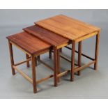 A mid-Century rosewood nest of 3 interfitting coffee tables, raised on square supports 46cm h x 59cm