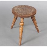 A circular hardwood 3 legged stool, the top carved a heptagram, 28cm h x 31cm diam. Contact marks