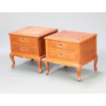 A pair of Chinese carved hardwood bedside chests of 2 drawers, raised on cabriole supports 51cm h