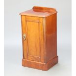 A Victorian mahogany pot cupboard with raised back enclosed by a panelled door 74cm h x 39cm w x