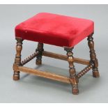 An 18th Century style rectangular oak framed stool, the seat upholstered in red material, raised