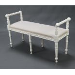 A 19th Century style white painted window seat with over stuffed seat, raised on 6 turned supports
