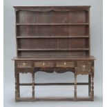 An 18th Century oak dresser of small proportions, the raised back with moulded cornice fitted 3