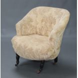 A Victorian tub back chair upholstered in yellow buttoned material, raised on turned supports 78cm h