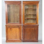 A pair of Victorian mahogany bookcases on cabinet with moulded cornice, the base fitted a brushing