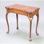 A 19th Century Georgian style shaped mahogany card table, the baise interior with counter wells