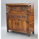 A reproduction 17th Century Ipswich style carved and inlaid oak court cupboard, the upper section