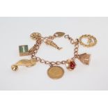 A 9ct yellow gold charm bracelet including a 1911 half sovereign, 30 grams of 9ct gold