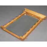 A Regency style rectangular bevelled plate pier mirror contained in a gilt painted frame with 2