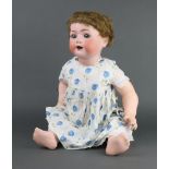 An early 20th Century Heubach Koppelsdorf bisque headed doll stamped 321.8 Germany, having open