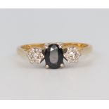 An 18ct yellow gold sapphire and diamond 3 stone ring, the centre stone 0.70ct, the outer 2 stones