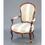 A Victorian rosewood show frame open arm chair upholstered in striped material raised on cabriole