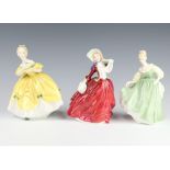 Three Royal Doulton figures - Autumn Breezes HN1934 19cm, Fair Lady HN2193 14cm and The Last Waltz