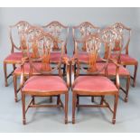 A set of 8 20th Century Hepplewhite style mahogany camel back dining chairs with pierced vase shaped