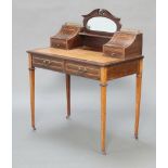 An Edwardian inlaid mahogany Carlton House style writing table with green inset leather writing