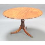 A circular Regency crossbanded mahogany snap top breakfast table raised on a turned column and